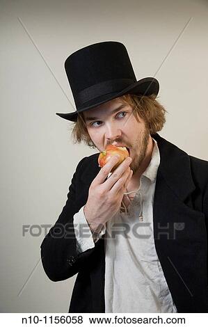 Young man eating an apple View Large Photo Image Stock Photo - Young man eating an apple. Fotosearch