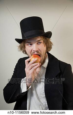 Young man eating an apple View Large Photo Image Stock Photo - Young man eating an apple. Fotosearch