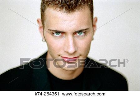 Young man gazing at camera View Large Photo Image Stock Image - Young man gazing at camera. Fotosearch