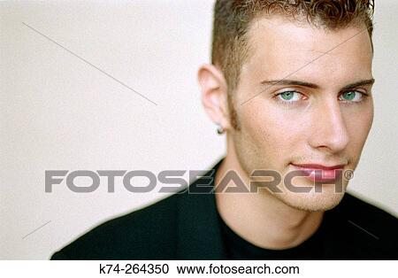 Young man glancing at camera View Large Photo Image Stock Image - Young man glancing at camera. Fotosearch