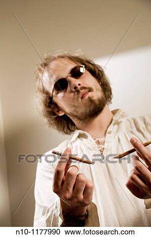 Young man holding a broken pencil View Large Photo Image Stock Image - Young man holding a broken pencil. Fotosearch