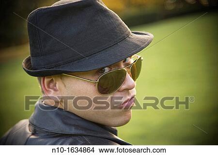 Young man in a park View Large Photo Image Picture - Young man in a park. Fotosearch