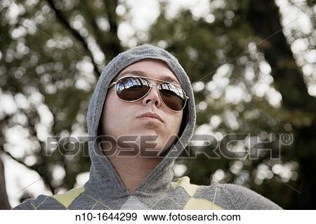 Young man in a park View Large Photo Image Stock Photo - Young man in a park. Fotosearch