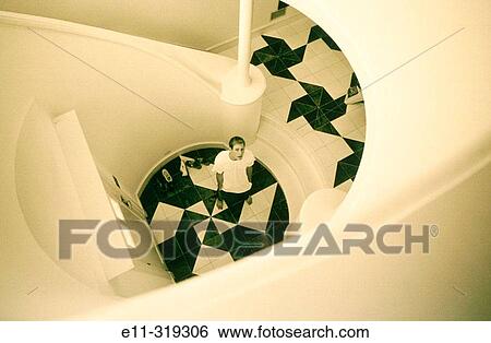 Young man in foyer View Large Photo Image Stock Photograph - Young man in foyer. Fotosearch
