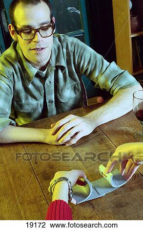 Young man in glasses playing cards View Large Photo Image Stock Image - Young man in glasses playing cards. Fotosearch