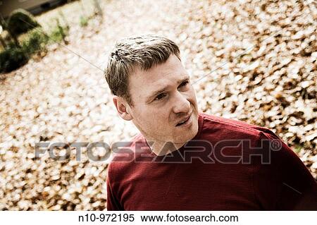 Young man in his backyard View Large Photo Image Stock Photography - Young man in his backyard. Fotosearch