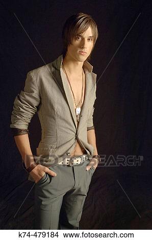 Picture - young man in suit jacket and no shirt. Fotosearch