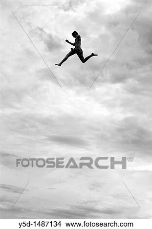 Picture - young man jumping from the tower to the jumps in the water, beach on the Geneva Lake in Geneva called? Paquis plage?, Geneva, Switzerland. Fotosearch