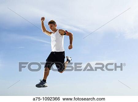 Young man jumping View Large Photo Image Stock Photograph - Young man jumping. Fotosearch