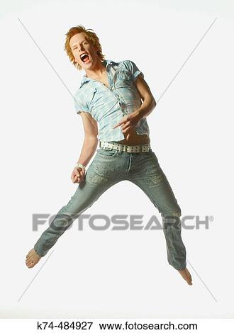 young man jumping while playing air guitar View Large Photo Image Stock Photo - young man jumping while playing air guitar. Fotosearch