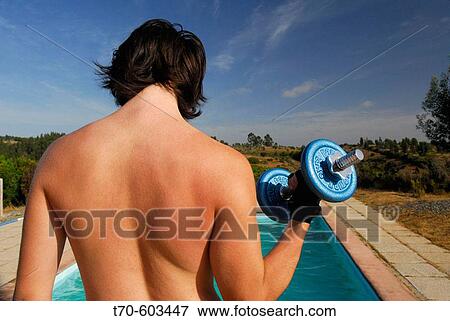 Stock Photo - Young man lifting weights. Chile. Fotosearch