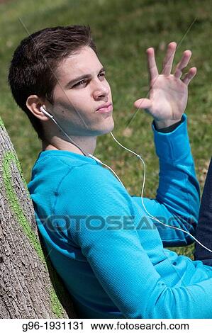 Young man listening music with earphones View Large Photo Image Stock Image - Young man listening music with earphones. Fotosearch