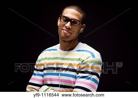 Young man listening to music. View Large Photo Image Picture - Young man listening to music.. Fotosearch