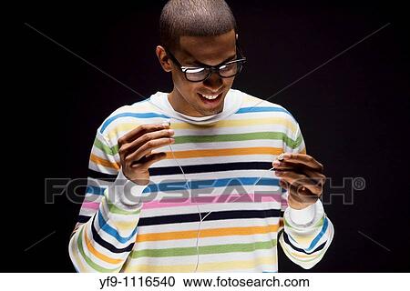 Young man listening to music. View Large Photo Image Stock Image - Young man listening to music.. Fotosearch
