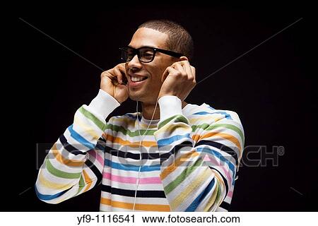 Young man listening to music. View Large Photo Image Stock Image - Young man listening to music.. Fotosearch