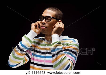 Young man listening to music. View Large Photo Image Stock Image - Young man listening to music.. Fotosearch