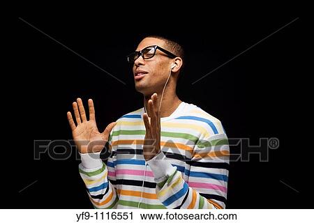 Young man listening to music. View Large Photo Image Stock Image - Young man listening to music.. Fotosearch