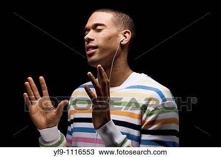 Young man listening to music. View Large Photo Image Stock Image - Young man listening to music.. Fotosearch