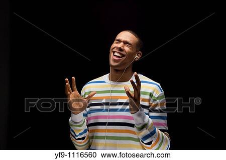 Young man listening to music. View Large Photo Image Stock Image - Young man listening to music.. Fotosearch