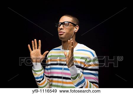 Stock Photo - Young man listening to music.. Fotosearch