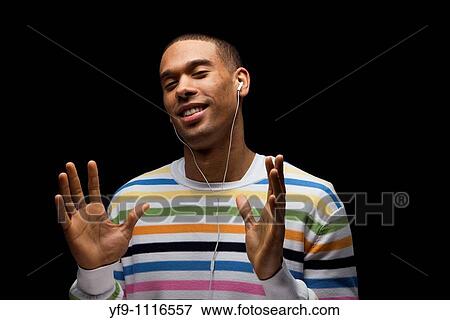 Young man listening to music. View Large Photo Image Stock Photo - Young man listening to music.. Fotosearch