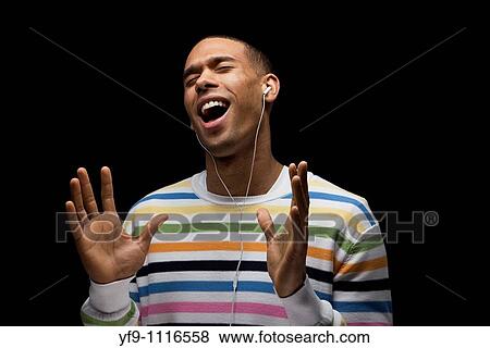 Young man listening to music. View Large Photo Image Stock Photo - Young man listening to music.. Fotosearch