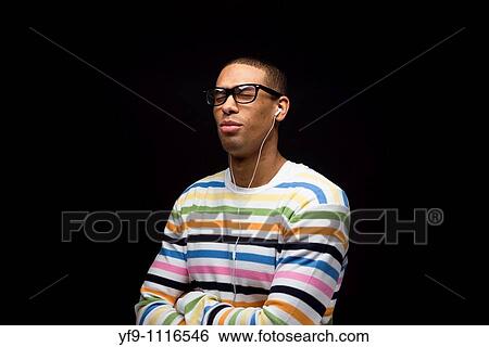 Young man listening to music. View Large Photo Image Stock Photograph - Young man listening to music.. Fotosearch