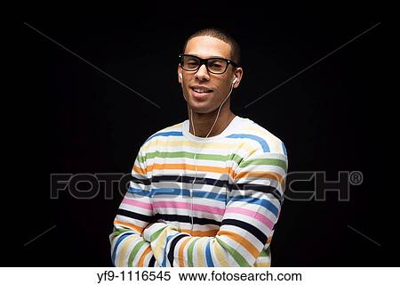 Young man listening to music. View Large Photo Image Stock Photography - Young man listening to music.. Fotosearch