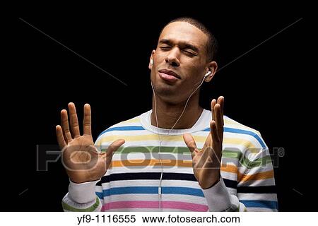 Young man listening to music. View Large Photo Image Stock Photography - Young man listening to music.. Fotosearch