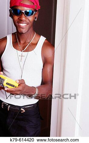young man listening to music with headphones View Large Photo Image Stock Image - young man listening to music with headphones. Fotosearch