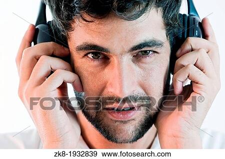 Young man listening to music with headphones View Large Photo Image Stock Photo - Young man listening to music with headphones. Fotosearch