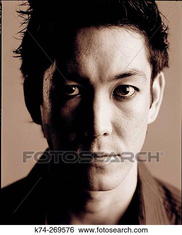 Stock Photograph - Young Man Looking At Camera. Fotosearch