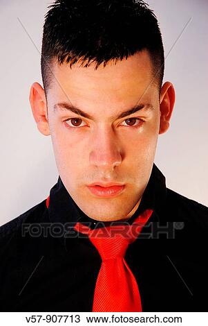 Stock Image - Young man looking at the camera. Close view.. Fotosearch