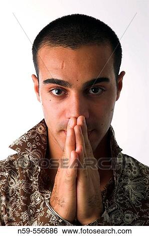 Young man of Middle Eastern appearance with hands held together in prayer position. View Large Photo Image Stock Photograph - Young man of Middle Eastern appearance with hands held together in prayer position.. Fotosearch