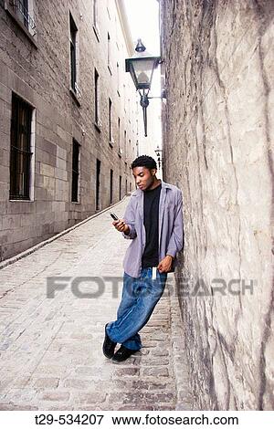 Young man on a cell phone. View Large Photo Image Stock Photo - Young man on a cell phone.. Fotosearch