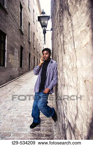 Young man on a cell phone. View Large Photo Image Stock Photo - Young man on a cell phone.. Fotosearch