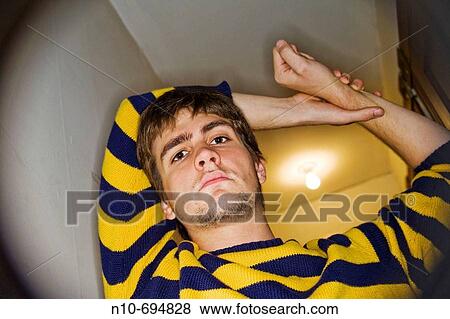 Young man posing in the hallway of his apartment View Large Photo Image Stock Photo - Young man posing in the hallway of his apartment. Fotosearch