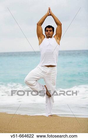 Young man practising yoga on the beach. View Large Photo Image Stock Image - Young man practising yoga on the beach.. Fotosearch