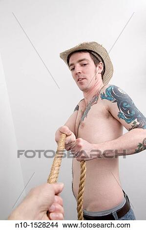 Young man pulling on a rope View Large Photo Image Picture - Young man pulling on a rope. Fotosearch