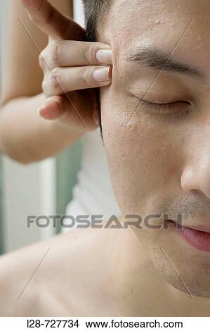 Young man receiving head massage, eyes closed, close-up View Large Photo Image Picture - Young man receiving head massage, eyes closed, close-up. Fotosearch