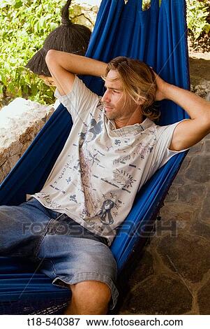 young man relaxing on hammock View Large Photo Image Stock Photo - young man relaxing on hammock. Fotosearch