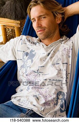 Stock Photo - young man relaxing on hammock. Fotosearch