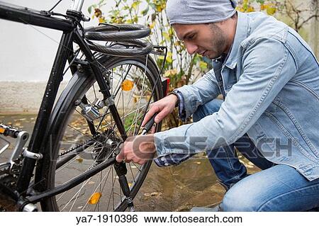 Young Man Repairing Bicycle View Large Photo Image Stock Photograph - Young Man Repairing Bicycle. Fotosearch