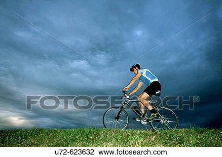 Young man riding a mountain bike View Large Photo Image Stock Image - Young man riding a mountain bike. Fotosearch