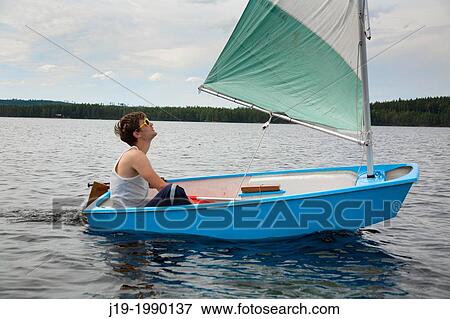 Young man sailing, Sweden View Large Photo Image Stock Photo - Young man sailing, Sweden. Fotosearch
