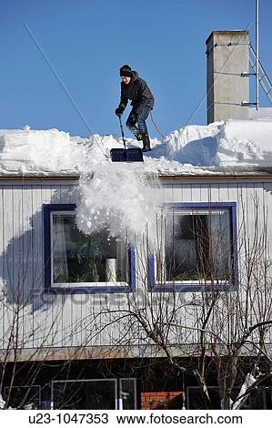 Young man shoveling snow from a roof. View Large Photo Image Stock Image - Young man shoveling snow from a roof.. Fotosearch
