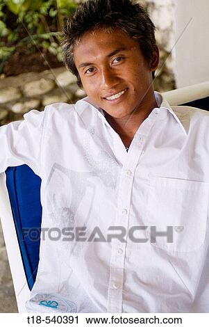 young man sitting and posing on couch View Large Photo Image Stock Image - young man sitting and posing on couch. Fotosearch