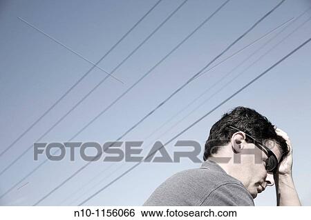 Young man sitting beneath power lines View Large Photo Image Stock Photograph - Young man sitting beneath power lines. Fotosearch