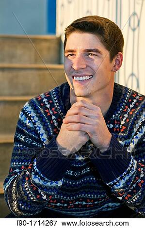 Young man sitting on stairs View Large Photo Image Stock Photo - Young man sitting on stairs. Fotosearch