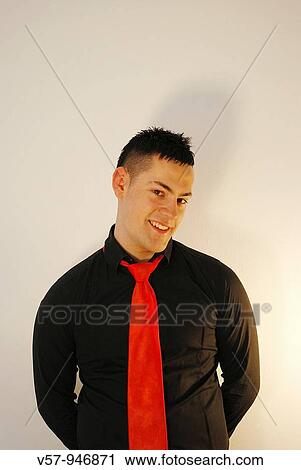 Young man smiling and looking at the camera View Large Photo Image Stock Image - Young man smiling and looking at the camera. Fotosearch
